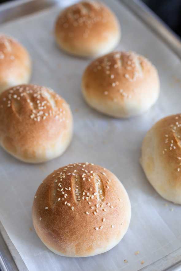 baked hamburger buns on a cookie sheet