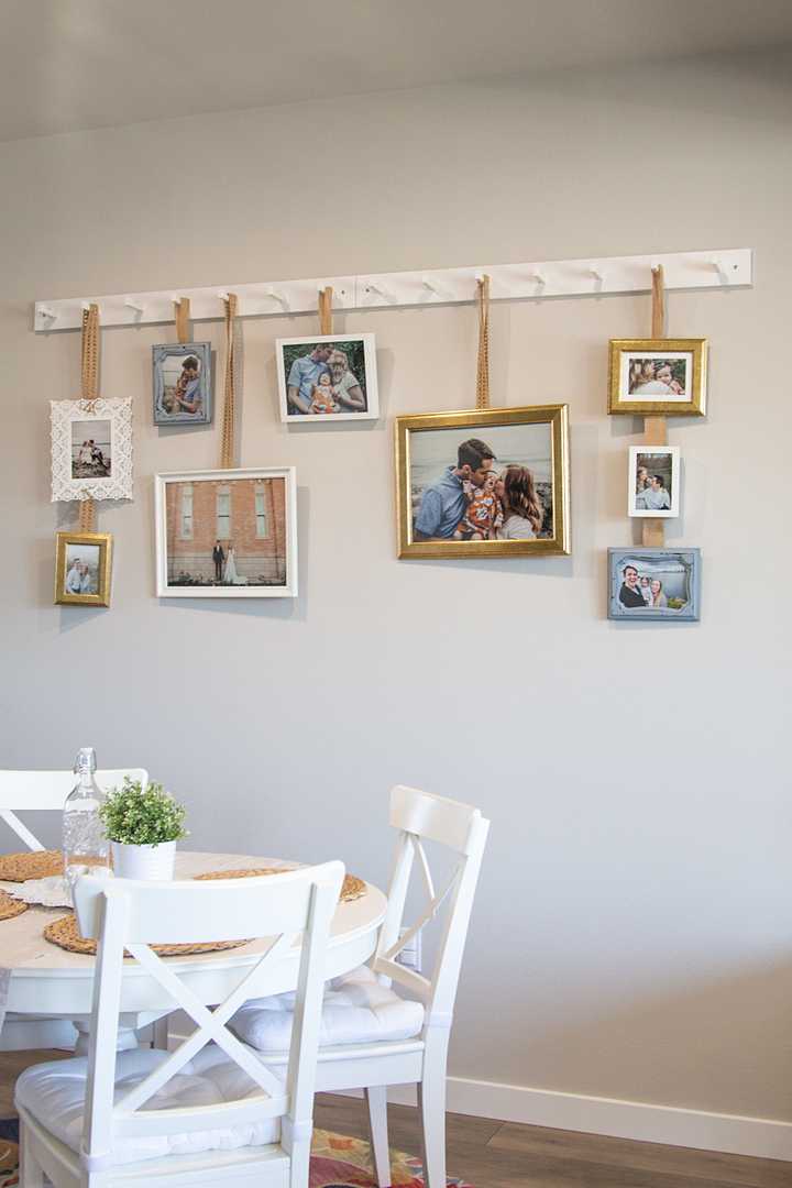Far shot of picture frames hanging on the wall by a kitchen table