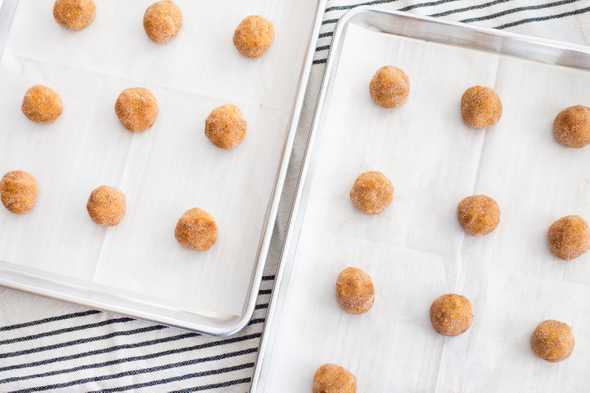 two trays of rolled cookie dough balls