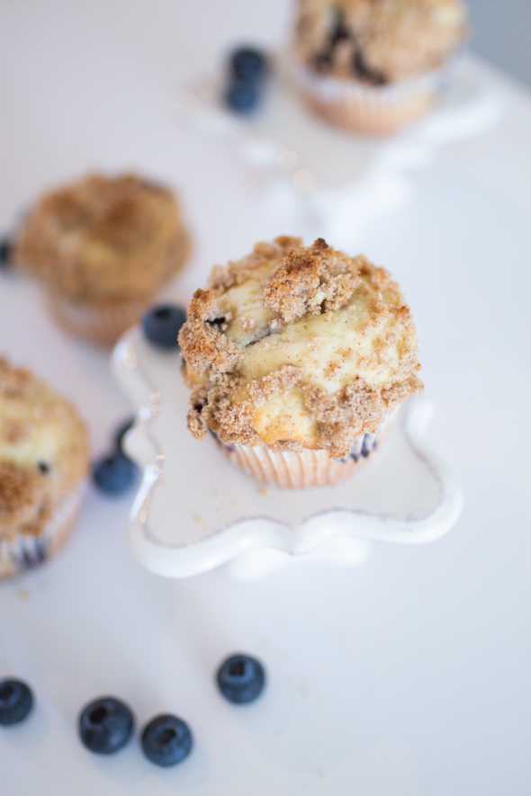 overhead shot of blueberry streusel muffins surrounded by fresh bluberries