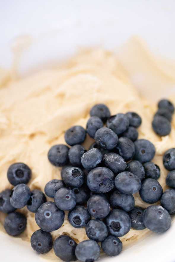 muffin batter with fresh bluberries on top