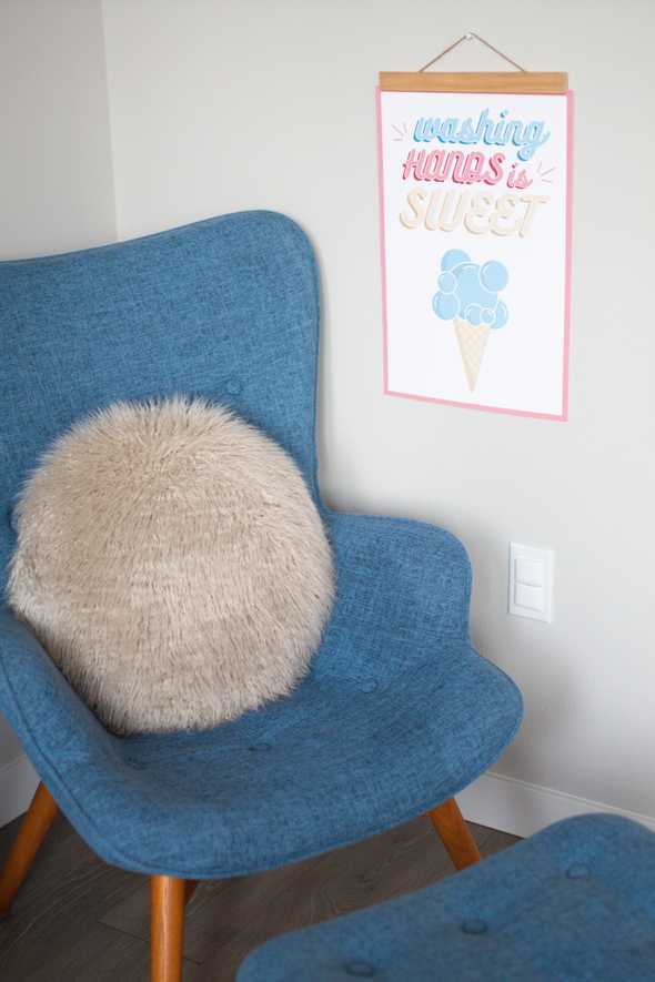 washing hands is sweet poster by a blue chair 
