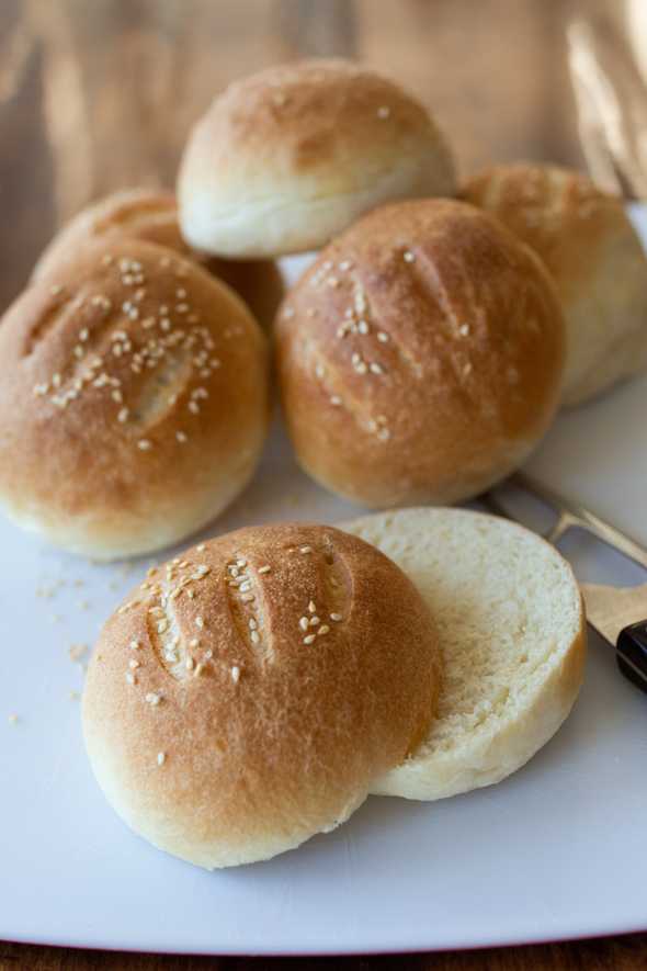 sliced hamburger buns on cutting board