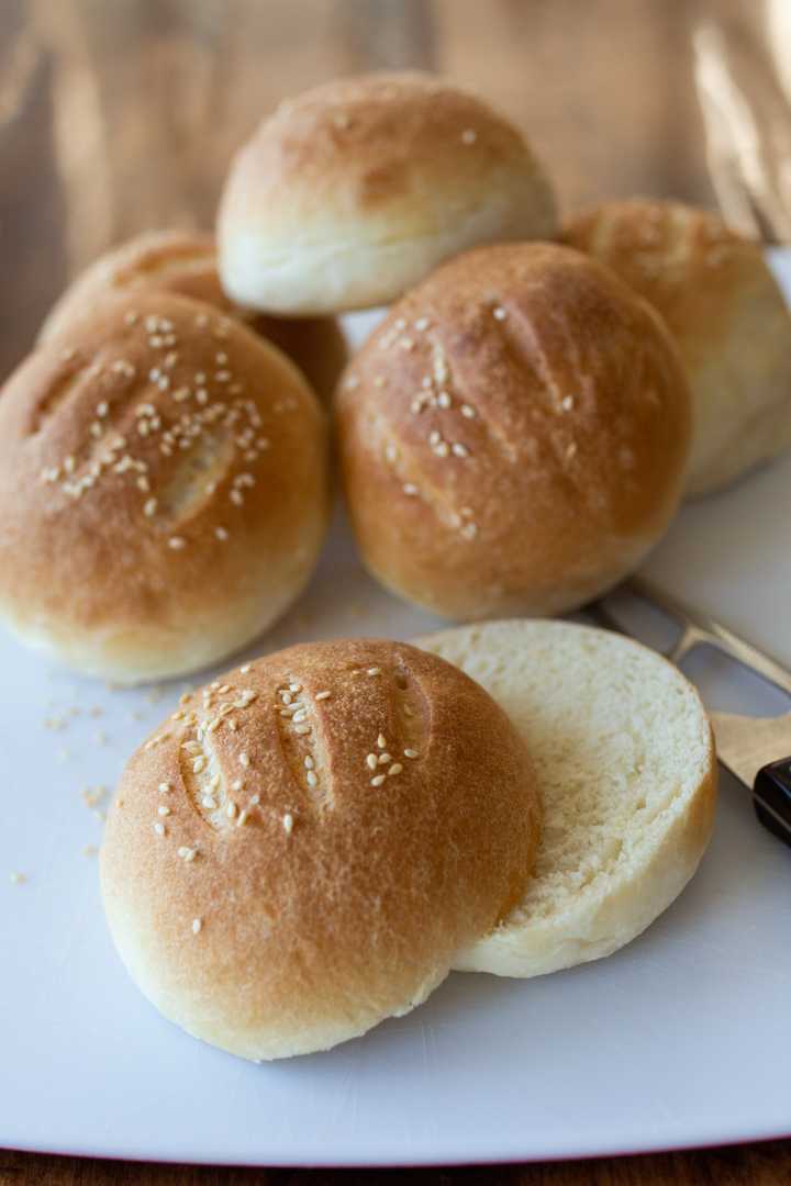 sliced hamburger buns on cutting board