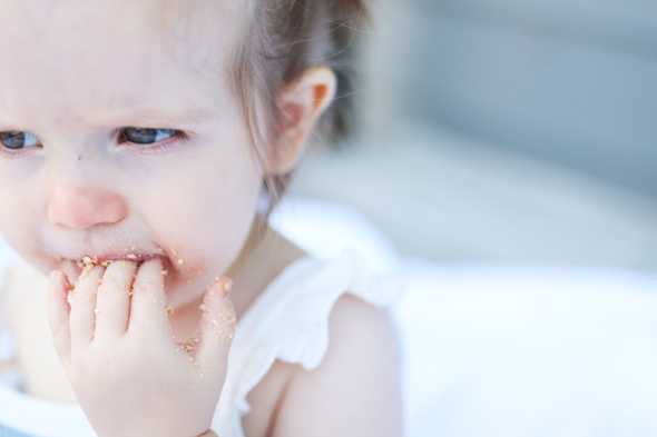toddler face covered in edible sand