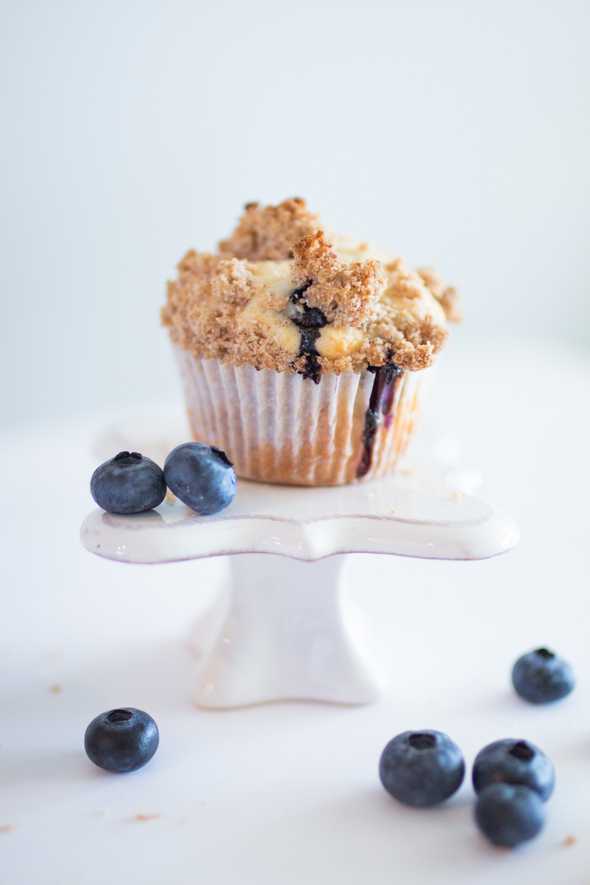blueberry streusel muffin surrounded by fresh bluberries