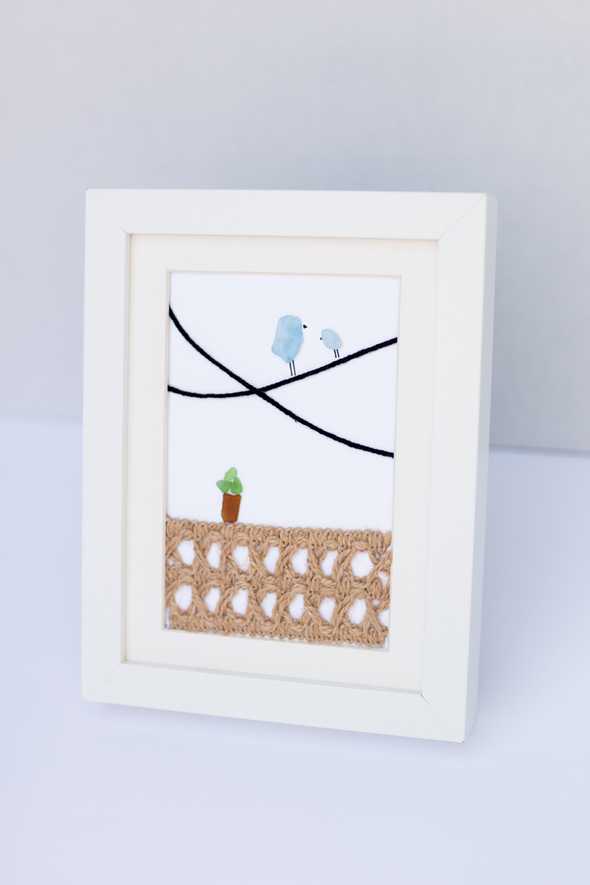 Sea Glass artwork of two birds in a frame