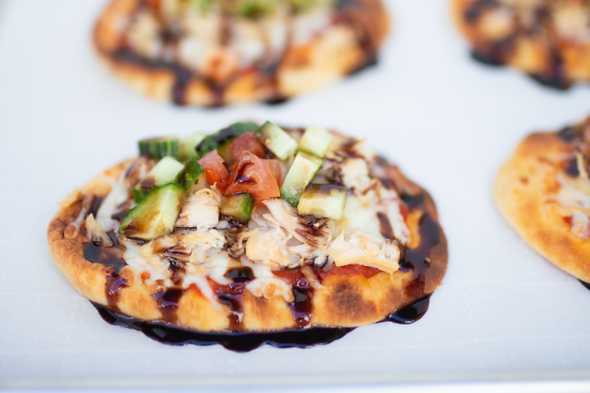 one raspberry balsamic bruschetta pizza on a baking sheet